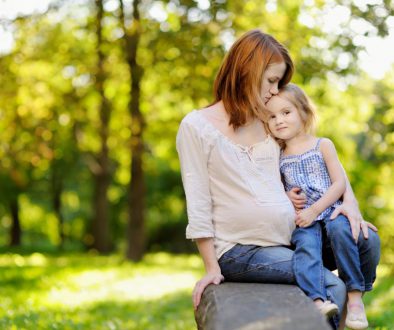 Pregnant mother with her daughter outdoors